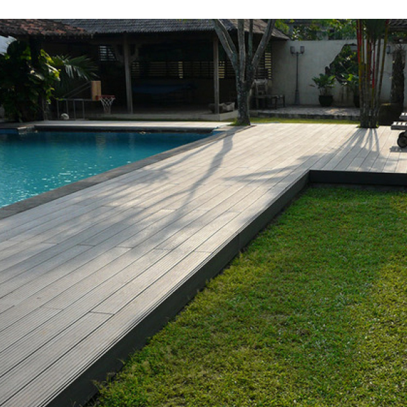 Picture of a pool and a patch of grass with a composite decking walkway through the middle
