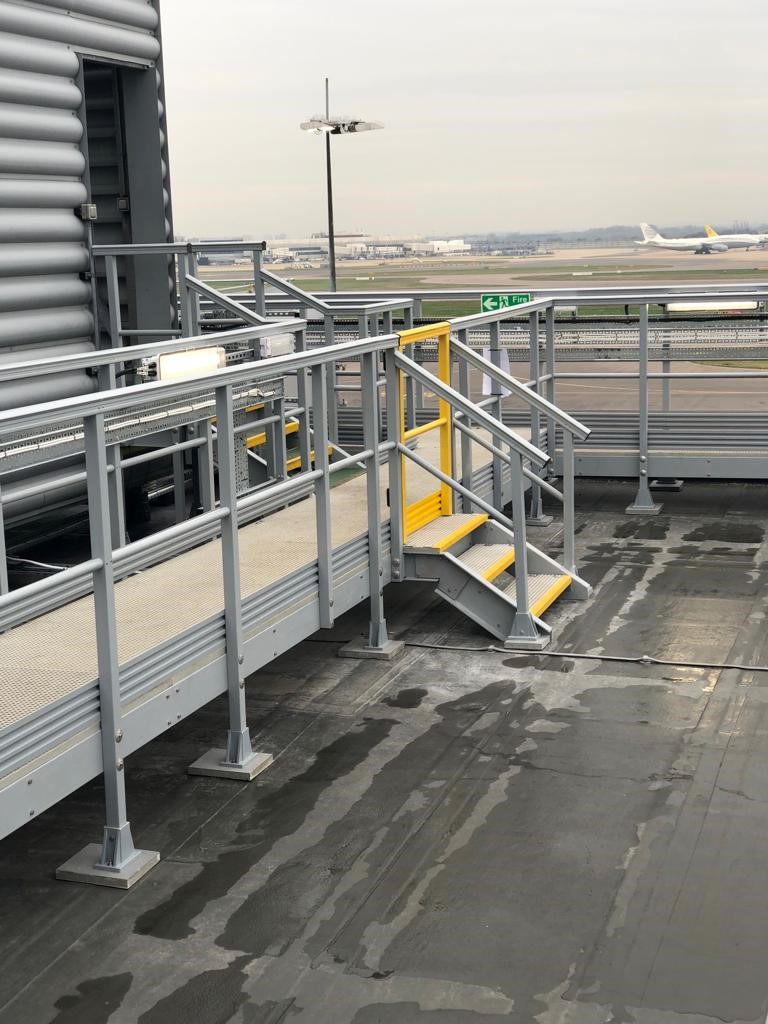 Rooftop access with GRP Handrail at Heathrow airport with planes in the background