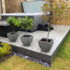 Ancient Wood WPC Decking project in a garden with a hot tub and plants on top