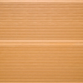 Close up of two WPC grooved decking boards in Teak
