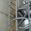 Ladder rung covers in use on a cat ladder, going up a storage tank
