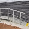 Grey mesh edging ramps either side of a platform