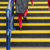 Children in school uniform walking up a staircase with tread covers on the stairs