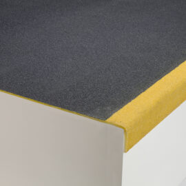 Close up of a landing cover with black flooring and yellow edging